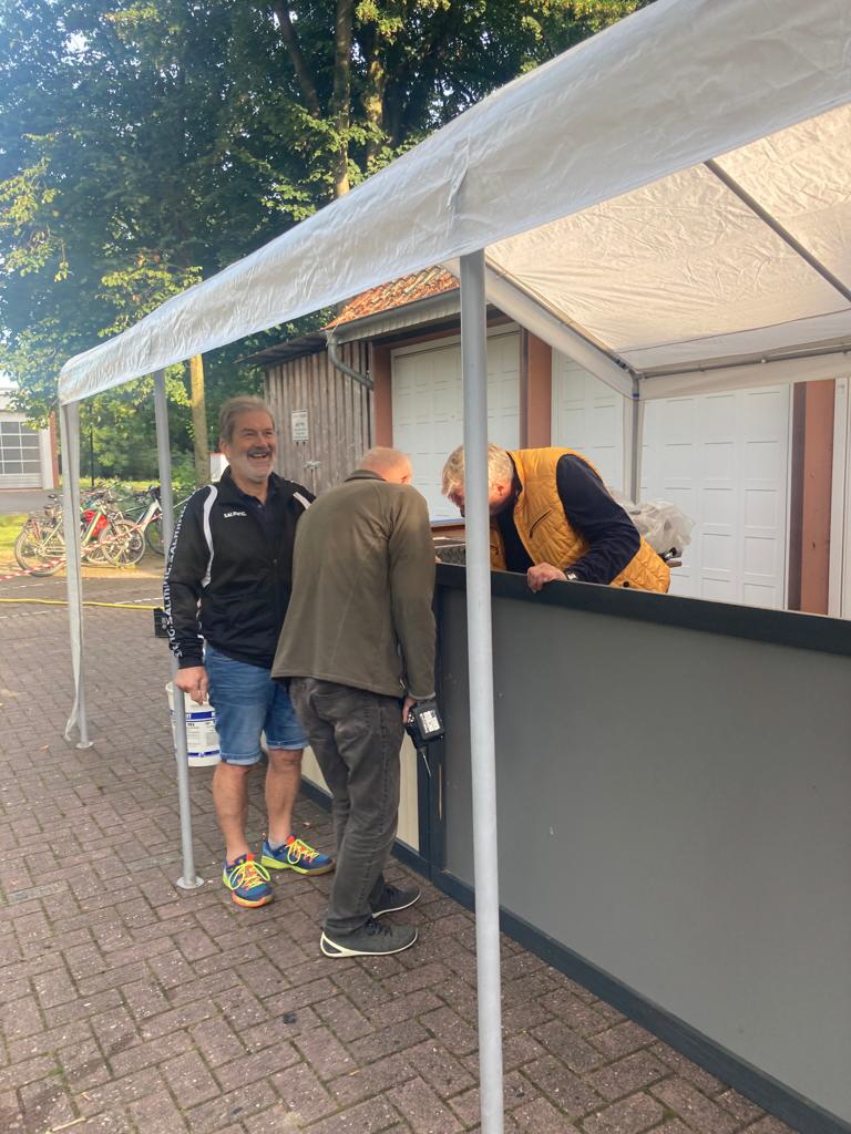 Dieter, Heiner und Hannes bauen den Grillstand auf.